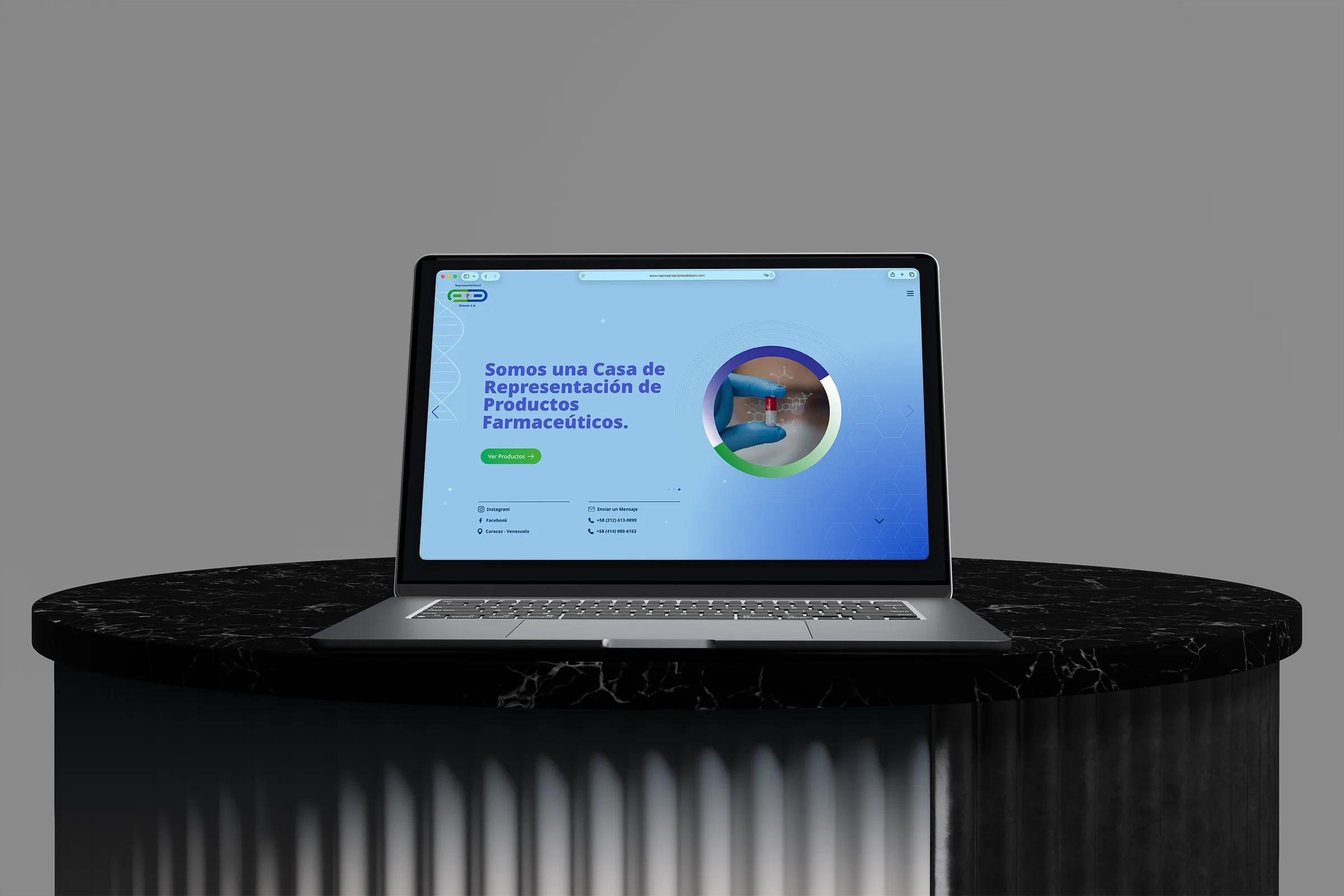Representaciones Diskam pharmaceutical website displayed on a laptop above a black marble pedestal.