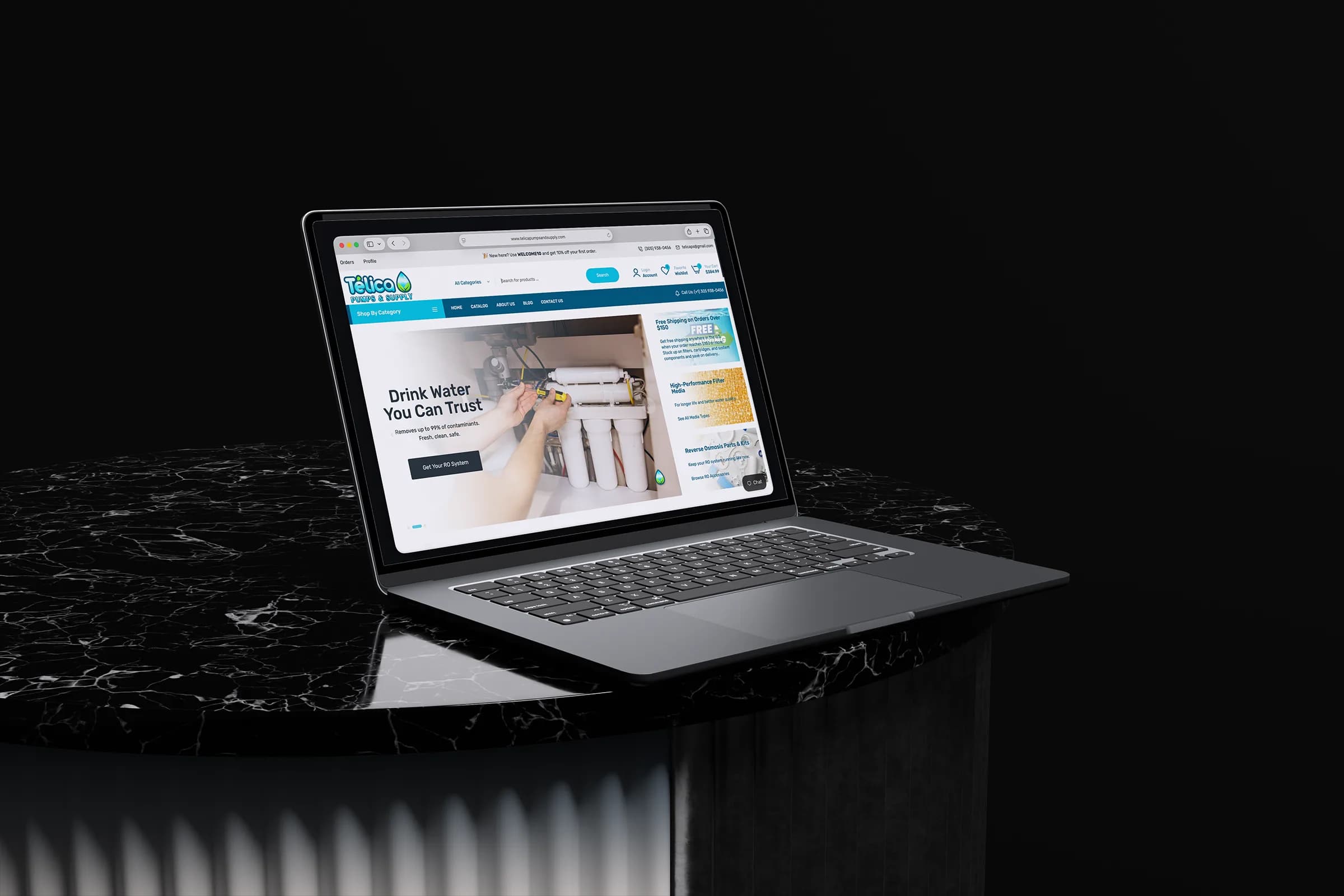 Telica Pumps & Supply storefront displayed on a laptop above a black marble pedestal.